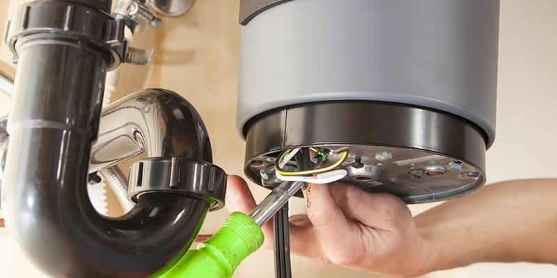 Technician repairing the heating element of a water heater in Longmont