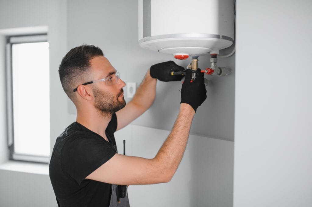 Technician performing water heater maintenance in Longmont